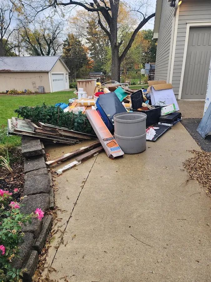 Dumpster being loaded with debris for Estate Cleanout Dumpster Rental in Lower Merion